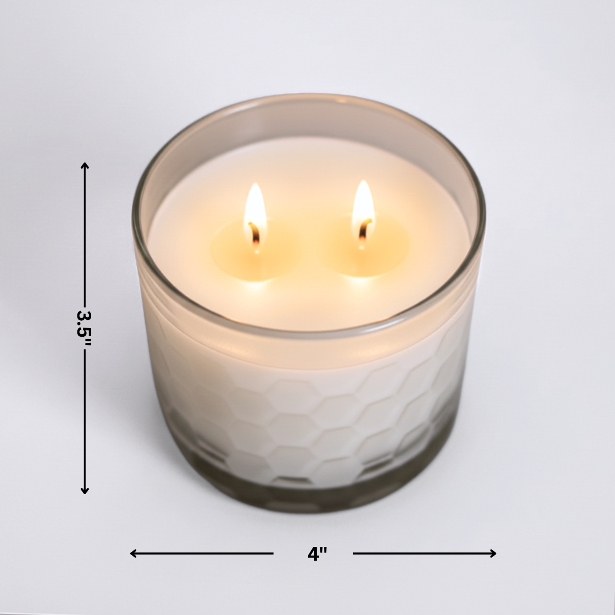 Candle in a glass container with dimensions indicated on a light gray background