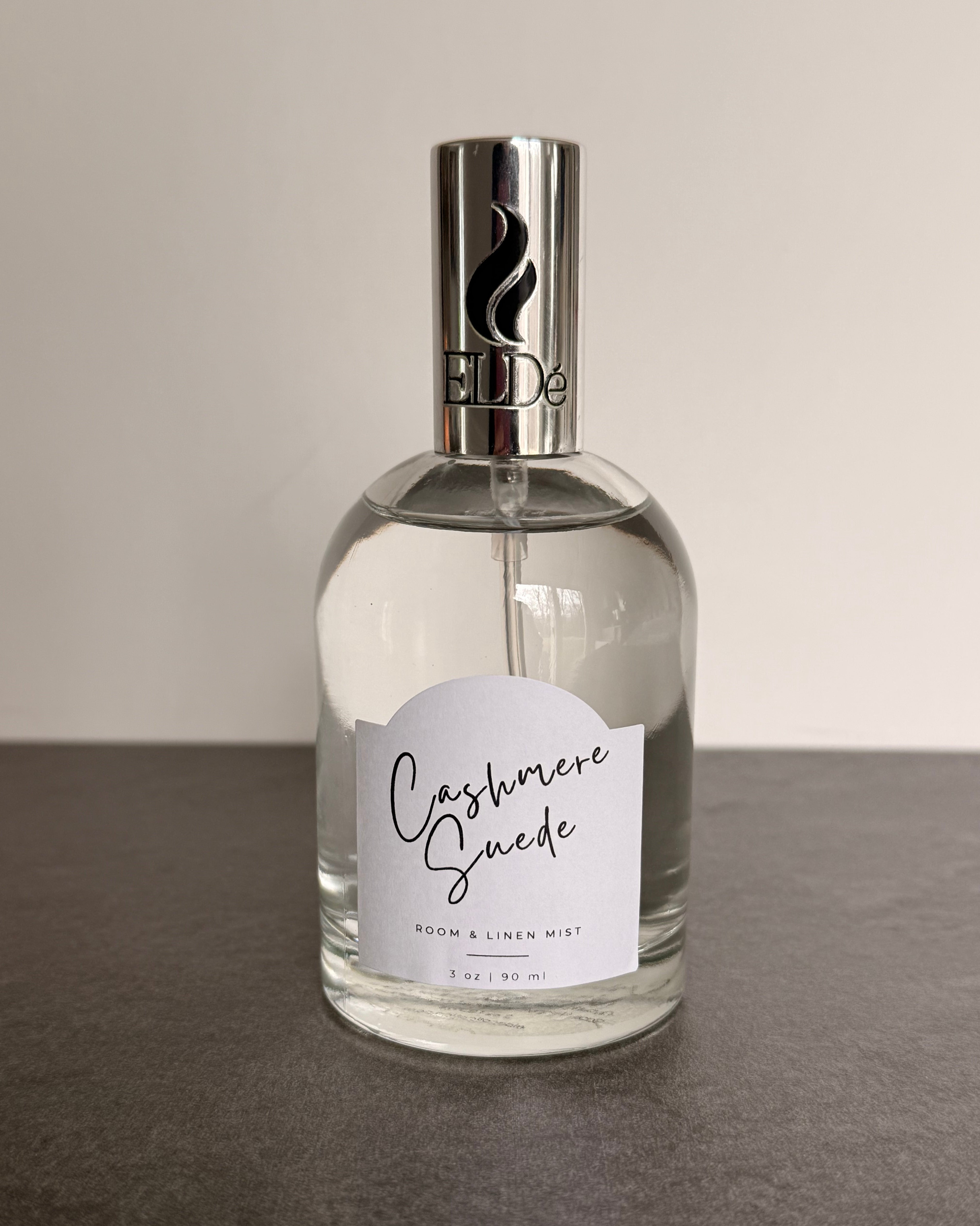 Perfume bottle labeled 'Cashmere Spice' on a neutral background