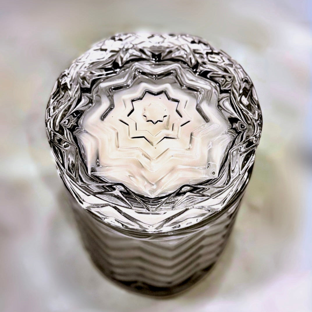 Close-up of a textured glass object with concentric patterns on a blurred background