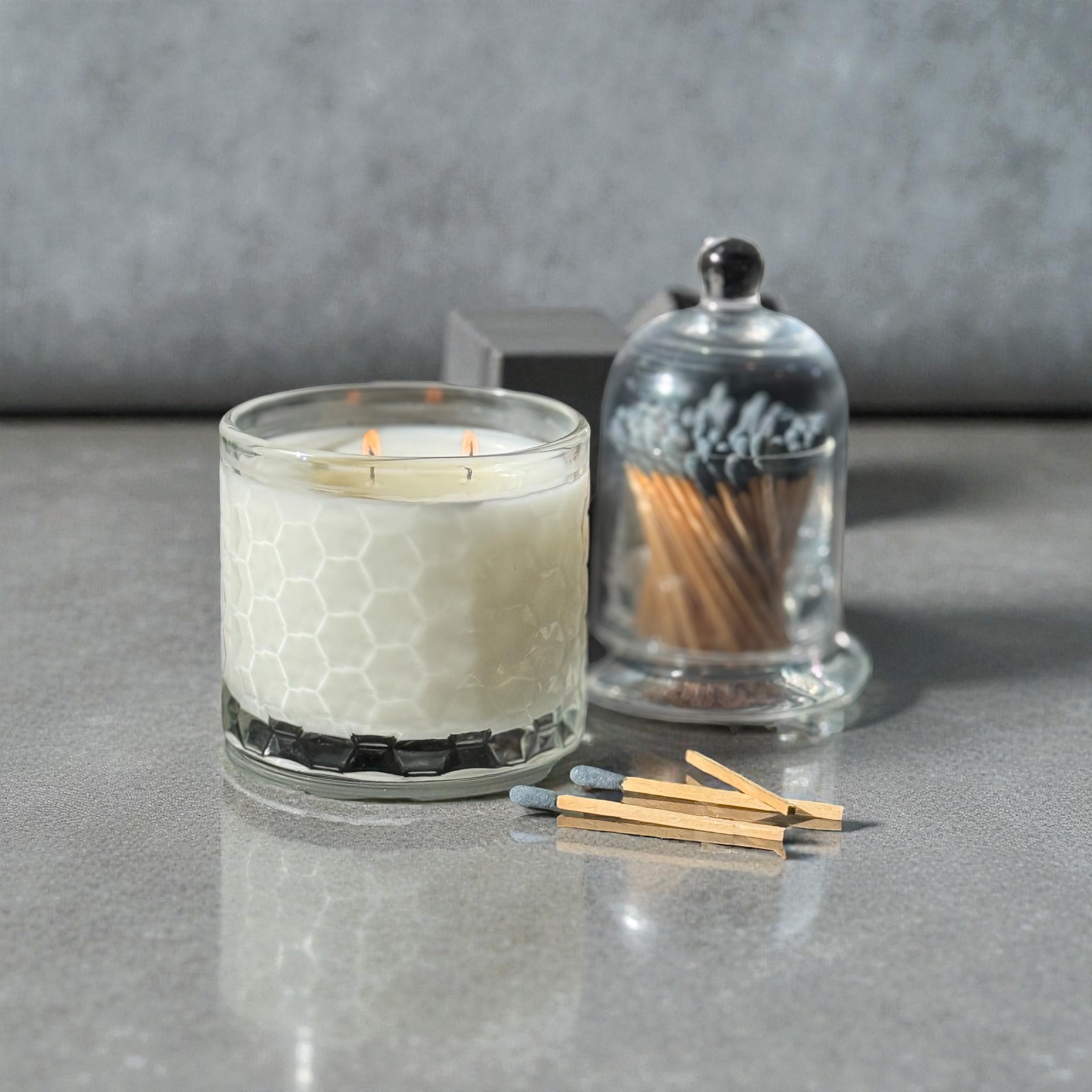 candle in glass container with matches