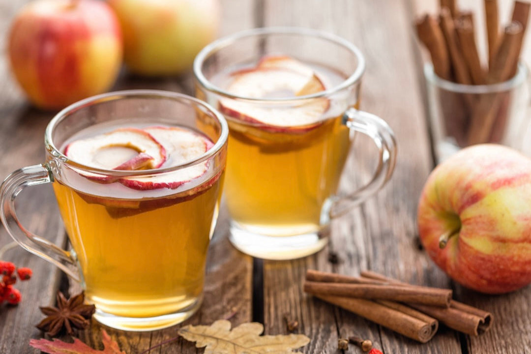 Three cups of hot mulled apple cider representing Mulled Orchard candle scent