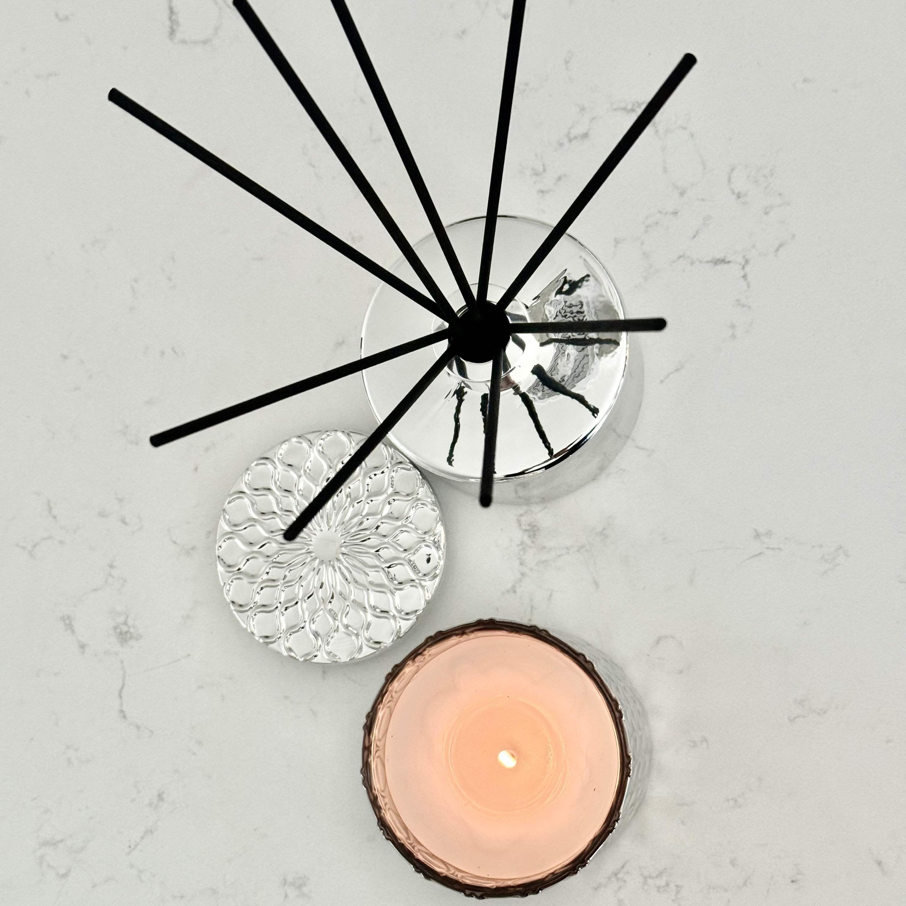 Decorative wall clock with black spike design on a light gray background