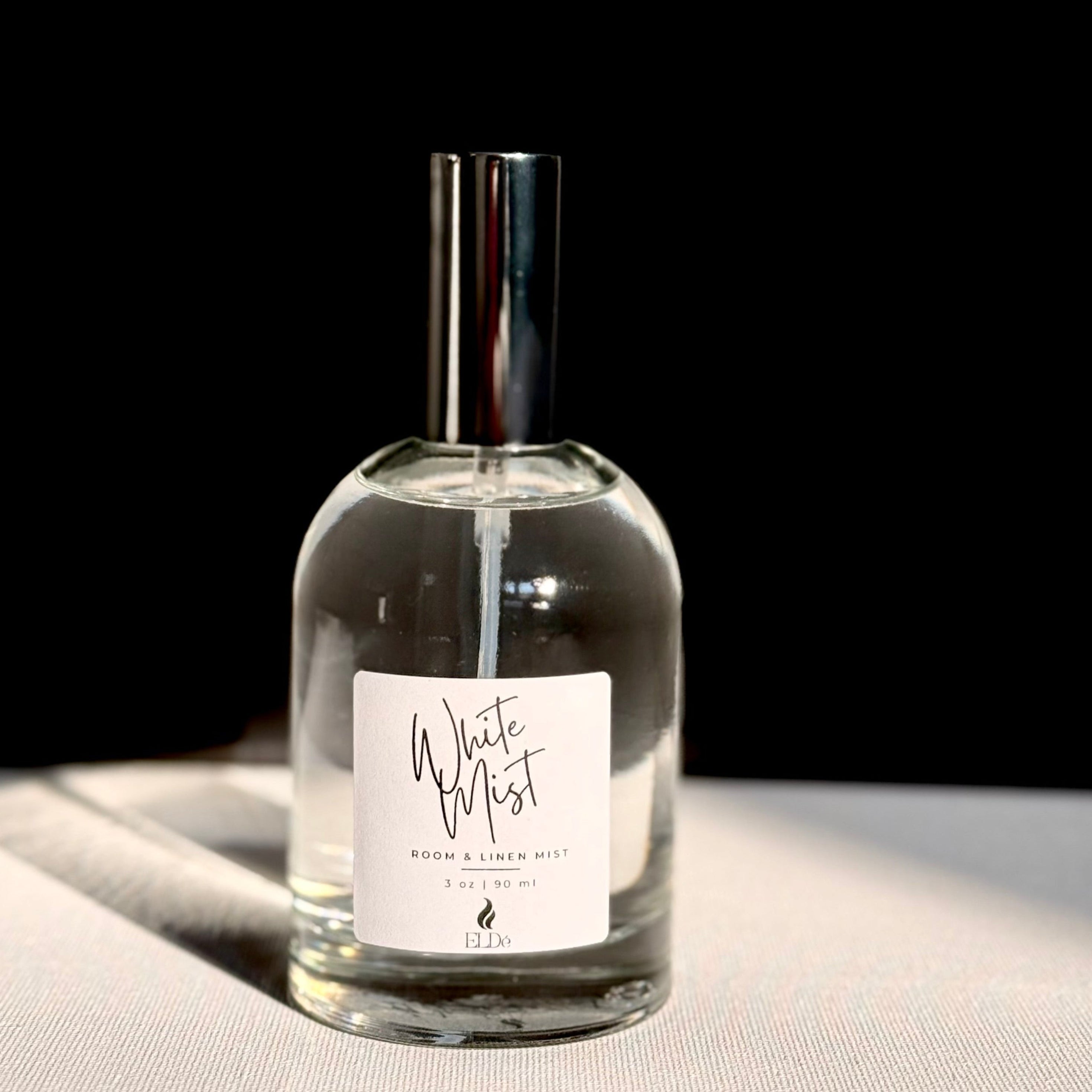 Clear glass bottle with a label on a light surface