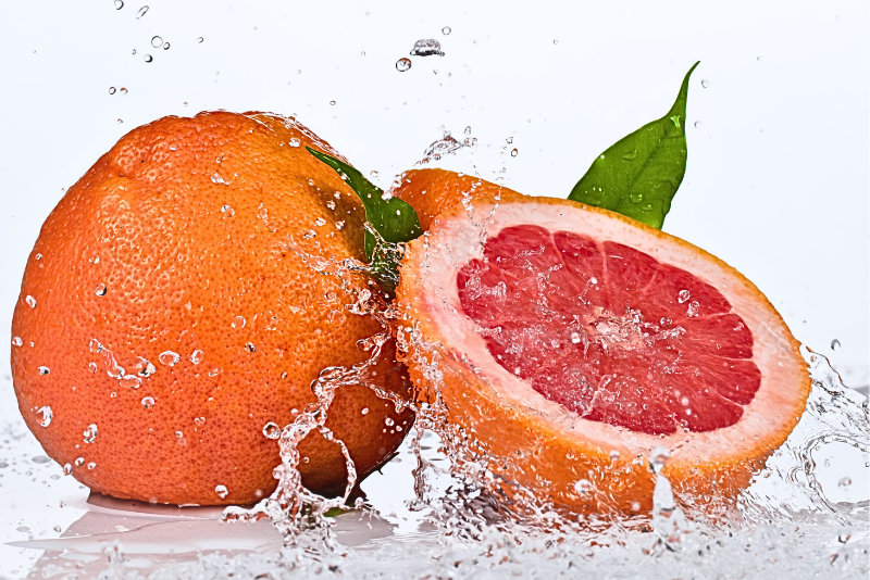 Grapefruit with water droplets on a white background