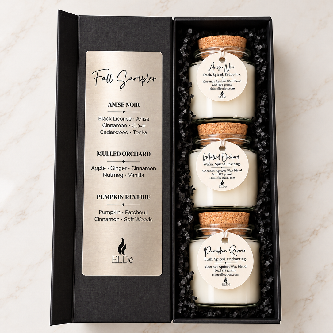 ELDé Fall Sampler gift box featuring three candles in Anise Noir, Mulled Orchard and Pumpkin Reverie, displayed with cork lids and scent tags in black crinkle paper.