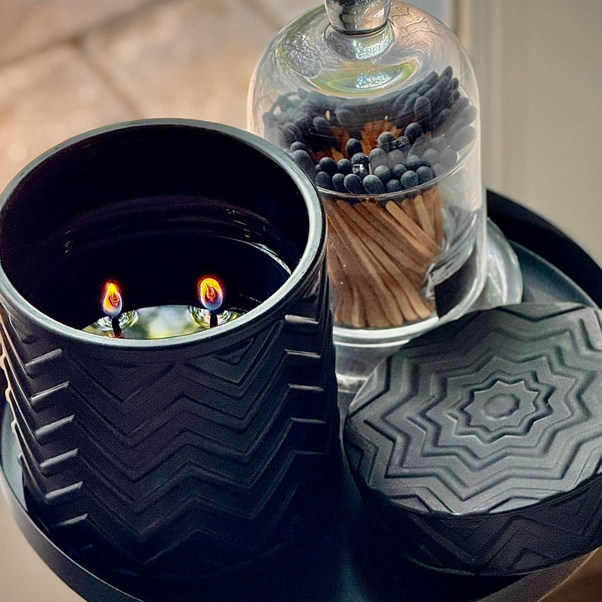 Onyx Moon Candle – Midnight Waves, top view with matches in glass cloche