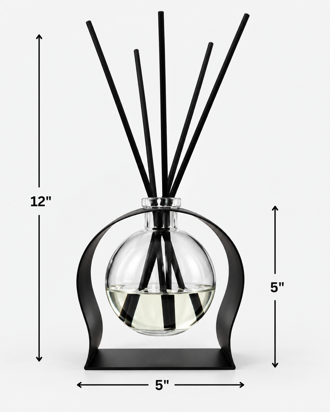 Radiance reed diffuser with clear glass vessel in a sculptural black metal stand and black reeds, shown with dimensions of 12 inches tall and 5 inches wide.