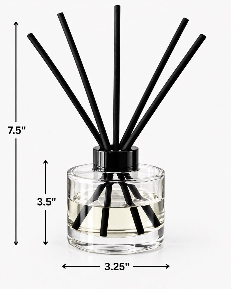 A reed diffuser bottle with clear glass, a black cap, and multiple black reeds, shown on a light gray background with dimensions.