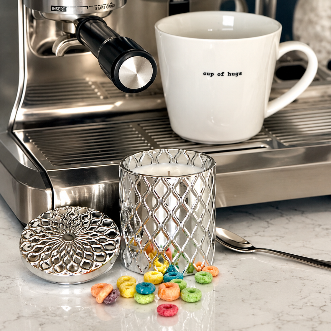 SilverScape candle beside a white coffee mug and espresso machine, styled on a marble counter with colorful cereal and matching decorative lid.