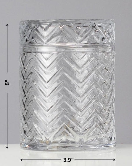 Clear glass tumbler with zigzag pattern and measurements on a gray background