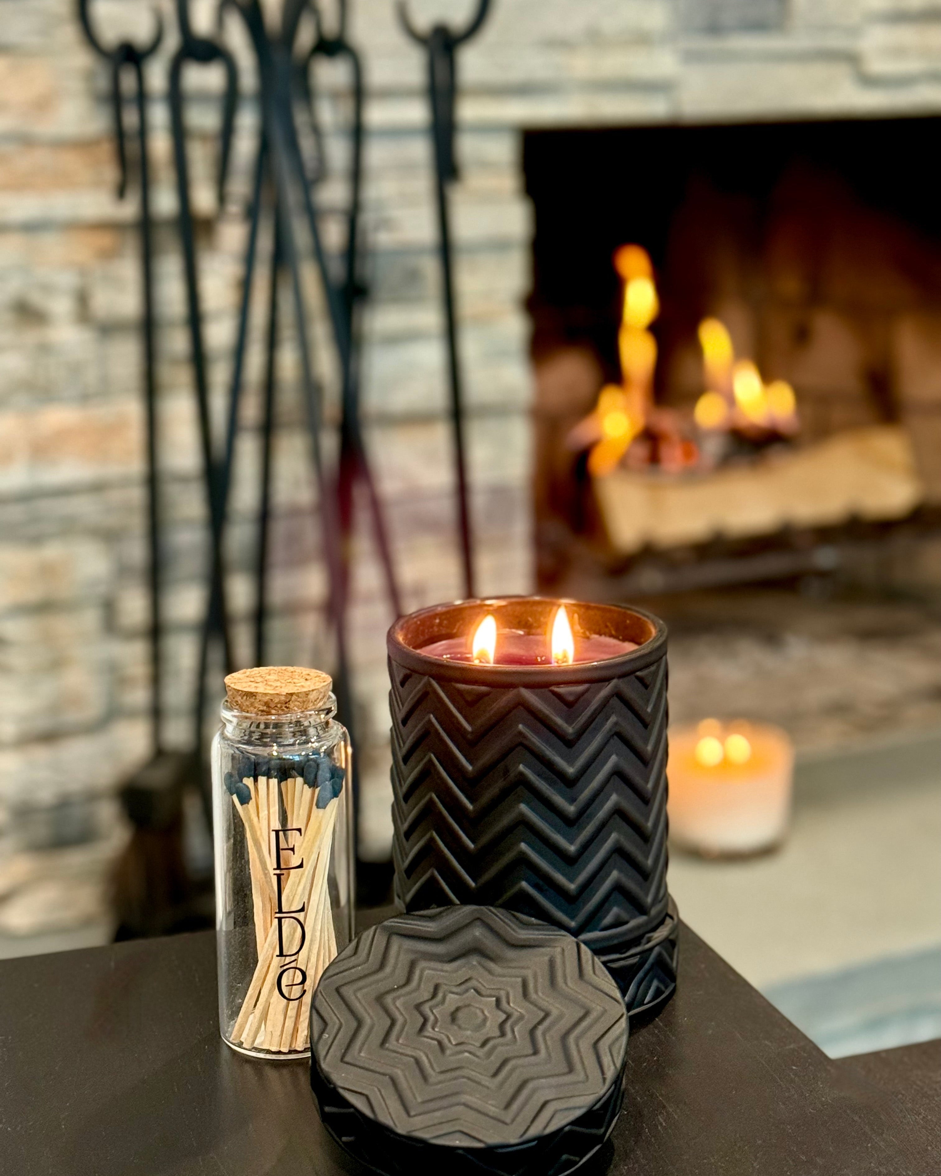 Close-up of Onyx Moon – Ember’s Embrace candle flame, showcasing elegant black glass vessel and warm amber light