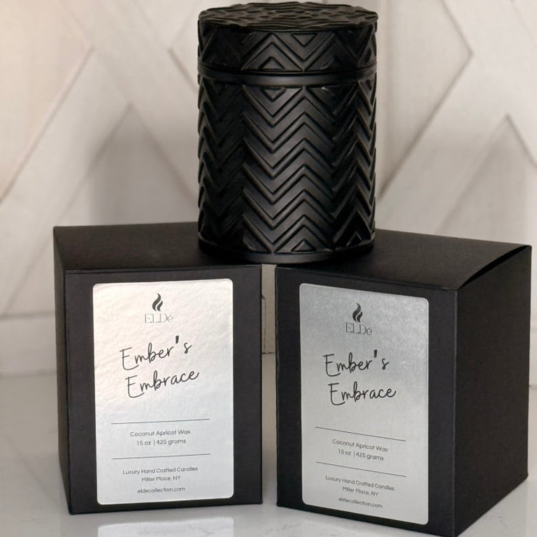 Black textured candle with 'Ember's Embrace' packaging on a white background