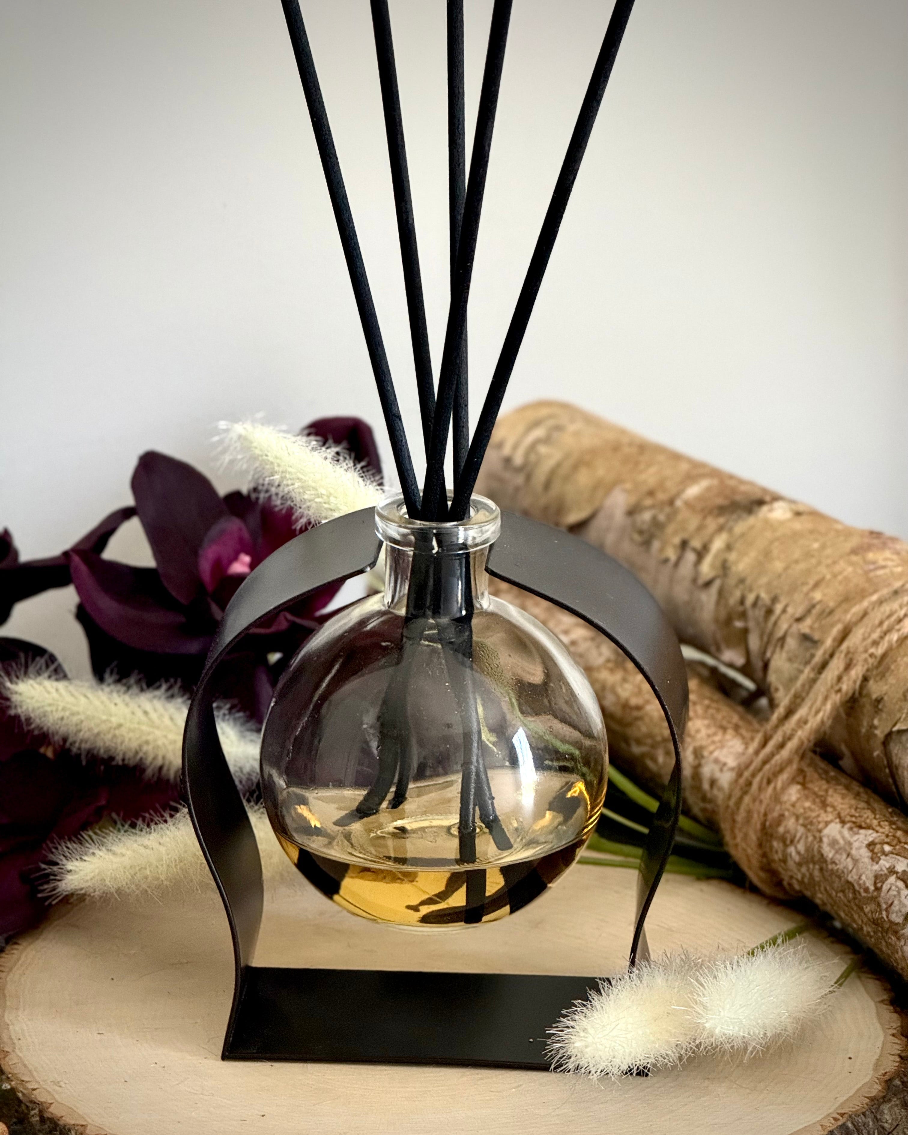 Radiance Reed Diffuser - Oakmoss & Amber Grove front view, sleek glass design