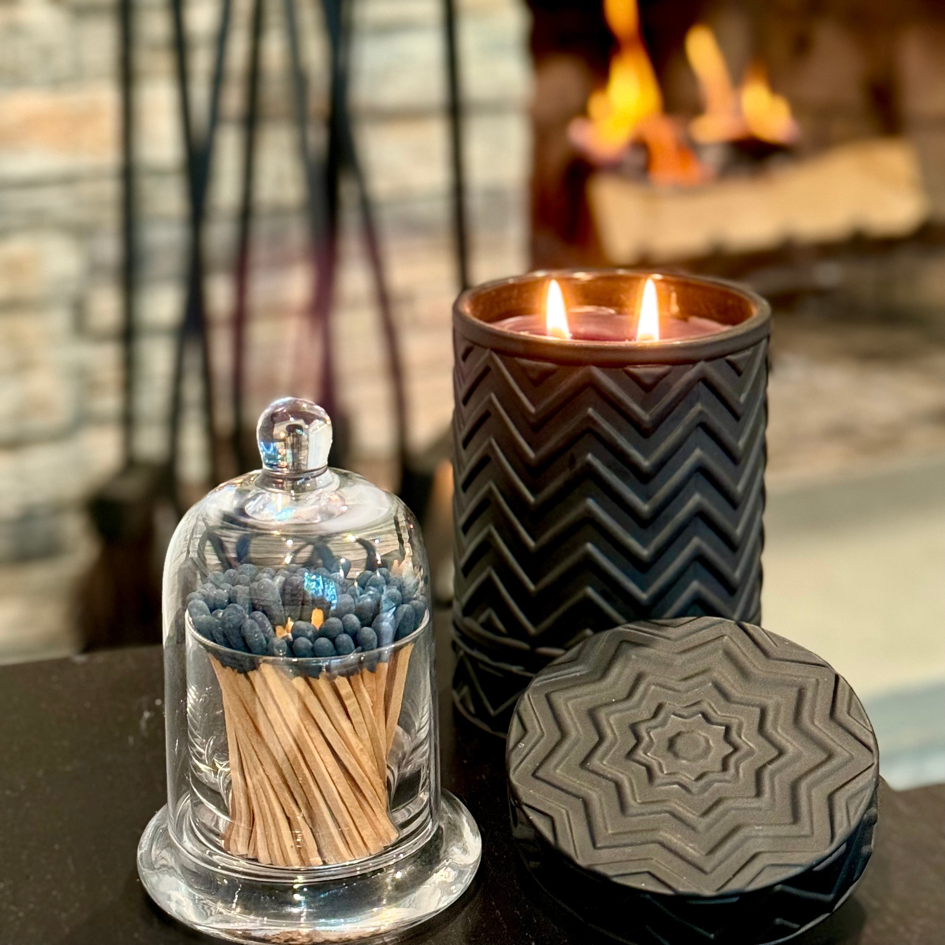 Onyx Moon – Ember’s Embrace luxury candle in a sleek black vessel with warm golden glow.