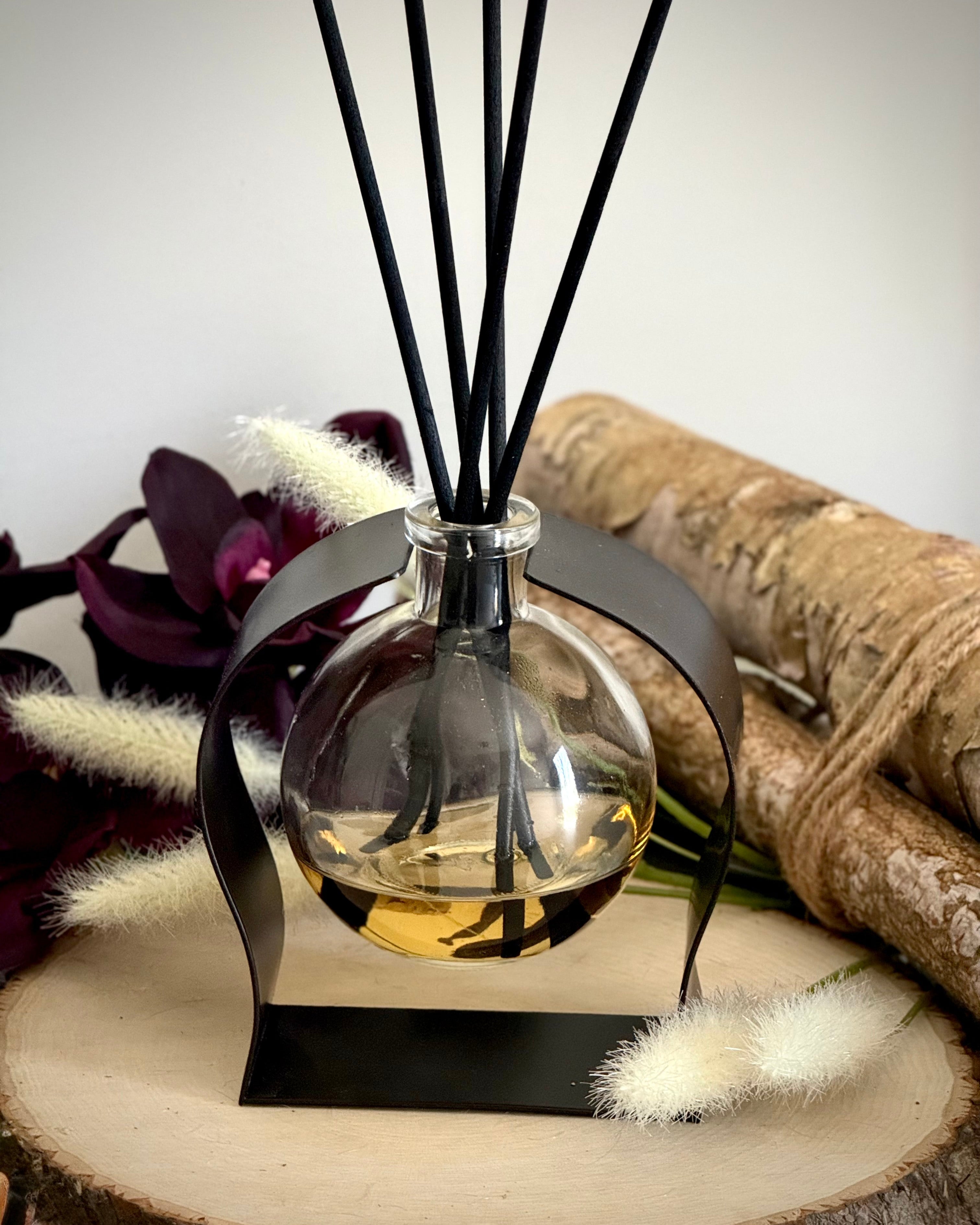 Radiance Reed Diffuser - Woodland & Mahogany Teak front view, sleek glass design